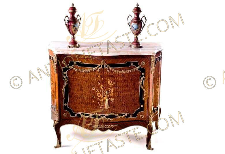 An exquisite 19th century Transitional style exotic wood, and ebony inlaid ormolu mounted cabinet, The legs are finished with ormolu sabots, The scalloped apron with an ormolu acanthus leaf motif, The cabinet doors has a parquetry inlay with a floral marquetry motif inlay, The inlay is trimmed with ebony color inlay with a twisted sweeping ormolu garland, The sides of cabinet have parquetry and foliage marquetry inlay, Topped with a sensational moulded veined white marble